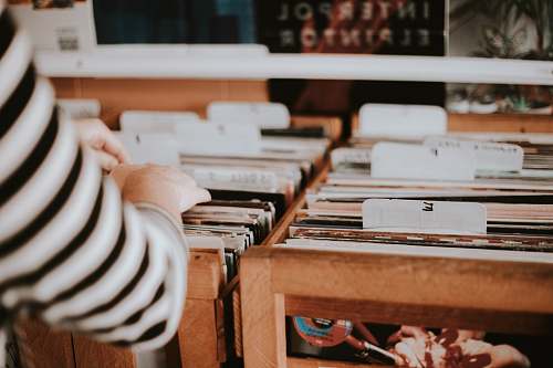 record store person holding folders record shop
